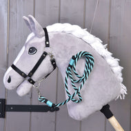 Grey Hobby Horse with a white braided mane and black halter, the Lead rope stripe green clipped under the chin