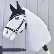 Grey Hobby Horse with a black halter and white fur mane wearing the black crocheted ear bonnet with gold trim