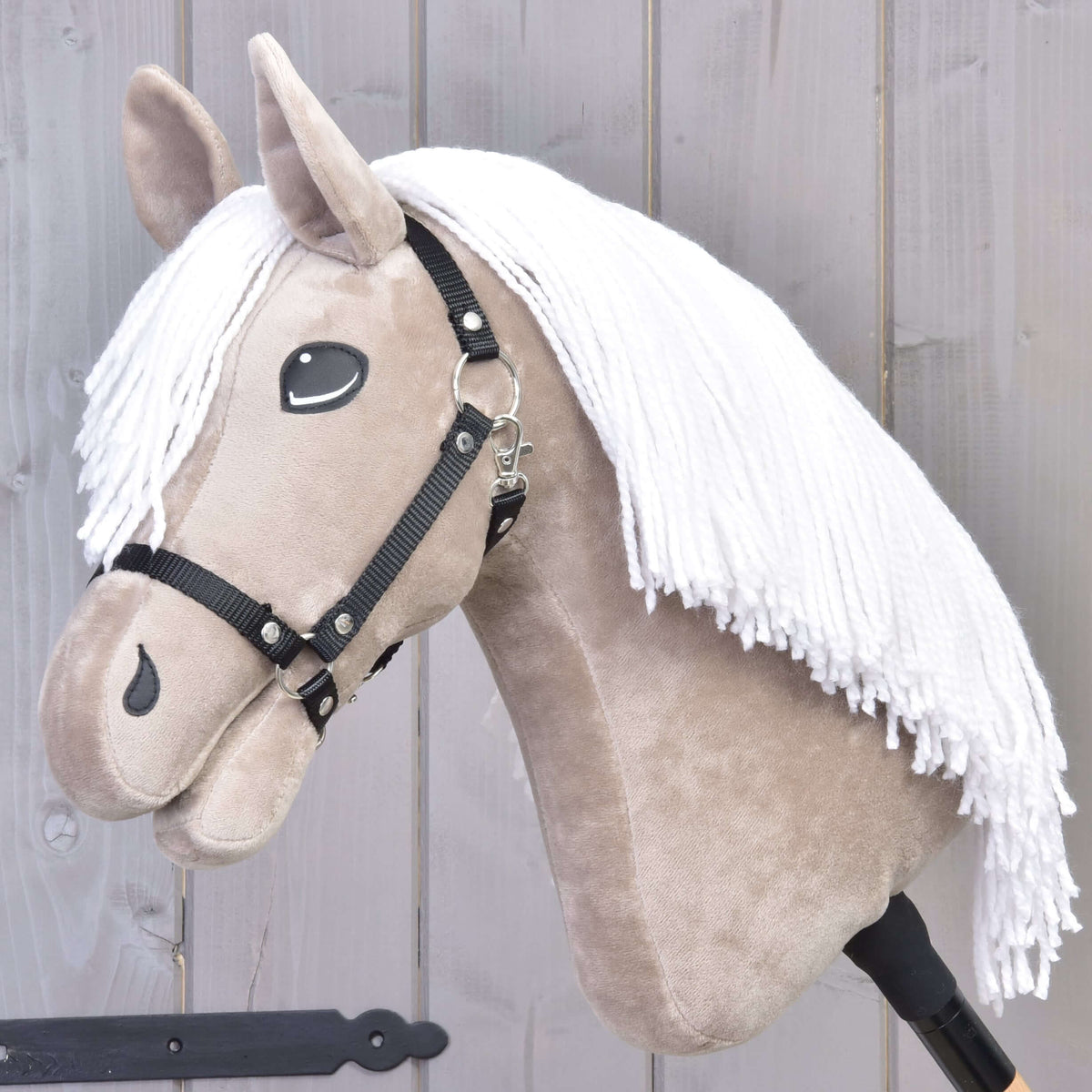 Hobby Horse Blondie with Black Halter by LarDen, a beige plush head with a long white yarn mane, side view