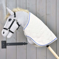 Grey Hobby Horse in a black halter wearing the Blanket Cream Pearl, cream quilting with royal blue piping over its neck