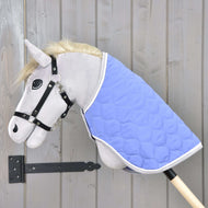 Grey Hobby Horse in a black halter wearing the quilted Blanket Light Violett with grey binding over its neck