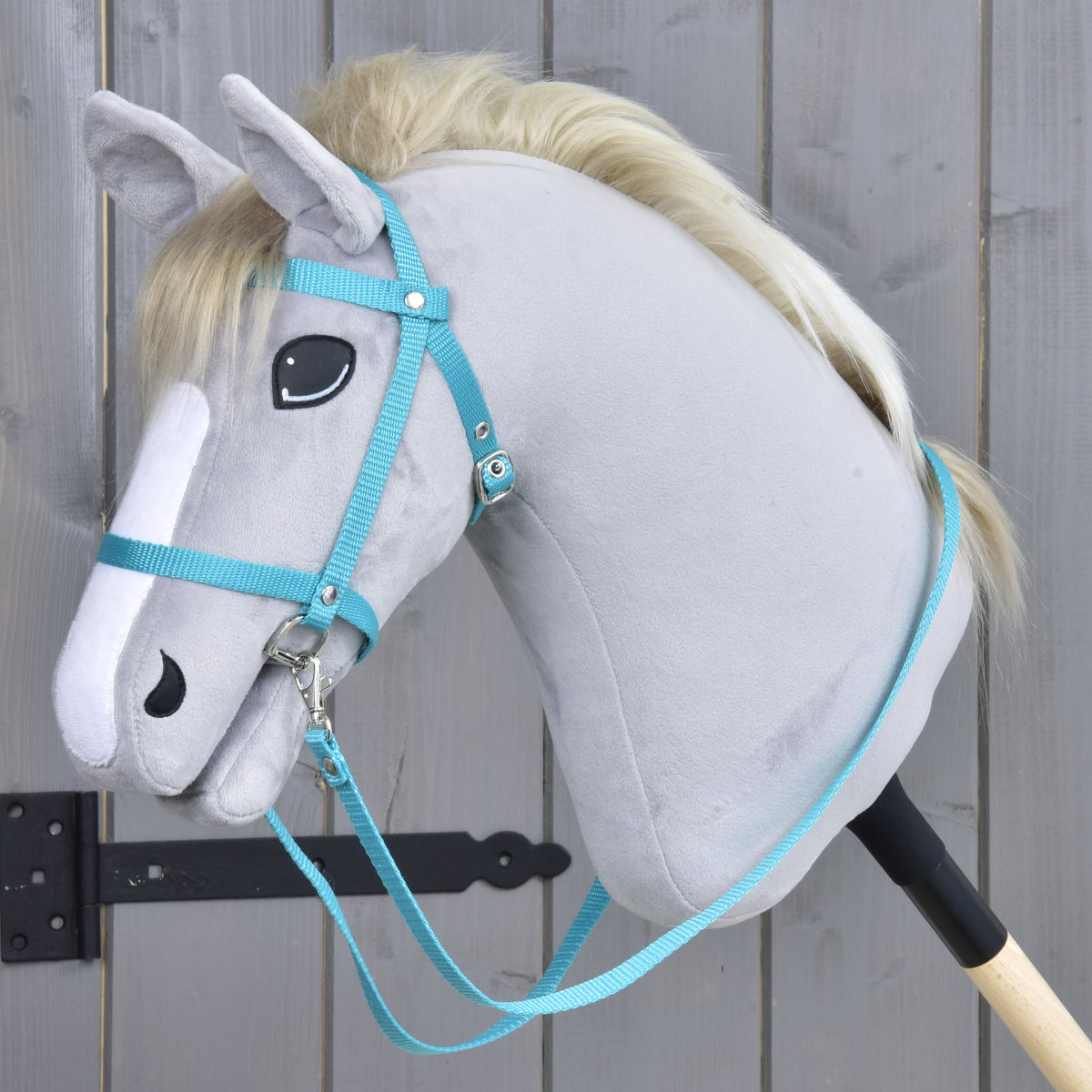 Hobby Horse Bridle with reins from strap turquoise by LarDen, worn on a light grey plush head with a blond mane