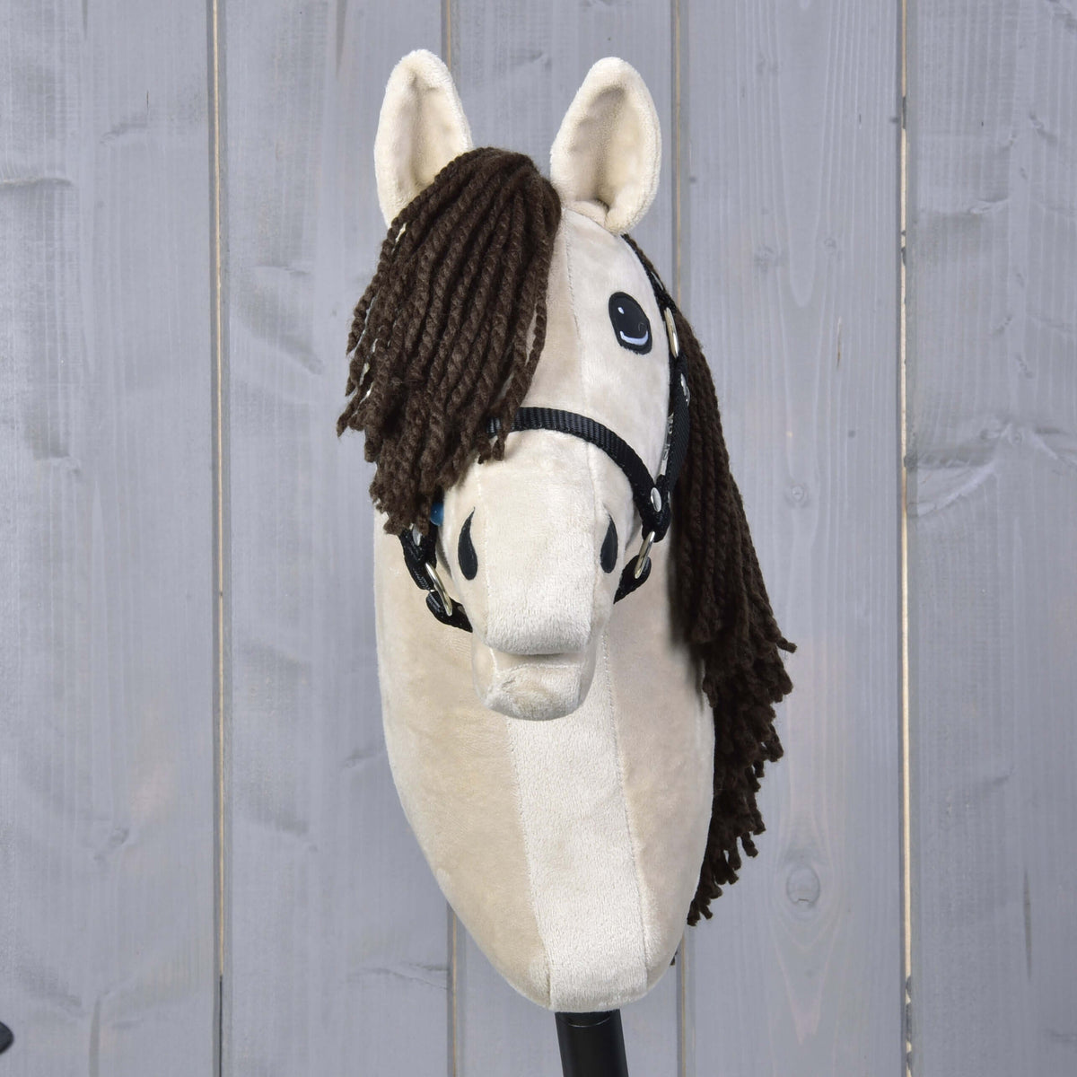 Hobby Horse Frederik LD with black halter seen from the front, thick brown yarn forelock and cream plush ears