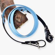 Hobby Horse Reins rubberized Light blue by LarDen, light blue middle and black buckle ends, looped over a pine branch