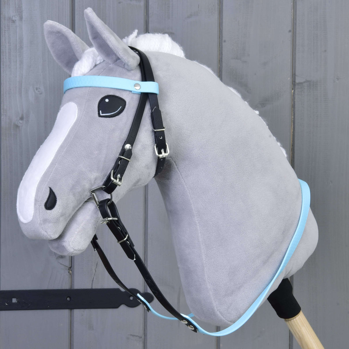 Complete bridle without noseband Light Blue by LarDen on a grey Hobby Horse, black straps with light blue browband and reins