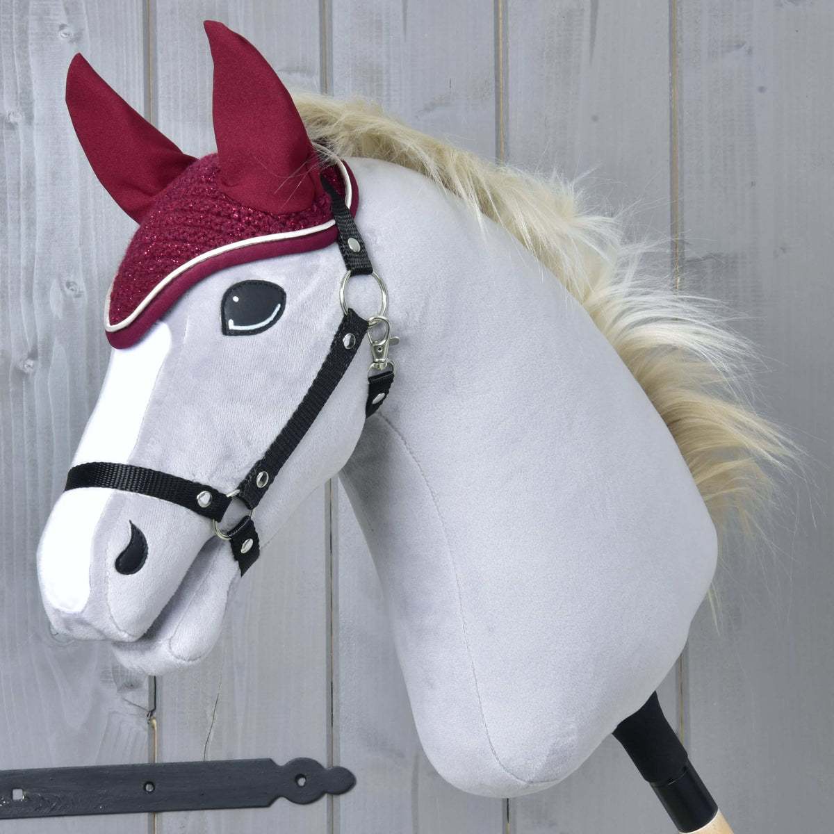 Grey Hobby Horse with a blond mane and black halter wearing the sparkly Ear bonnet crocheted Lux Maroon