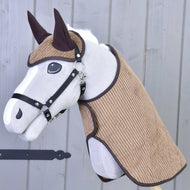 Grey Hobby Horse in a black halter wearing the light brown corduroy blanket and ear bonnet with dark brown trim