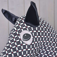 Close-up of the Hobby Horse protective suit DeLuxe: black satin ear and eye opening in the geometric print