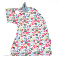 Tropical print protective suit laid flat from the side, white Lycra with pink flamingos, palm leaves and a sage ear