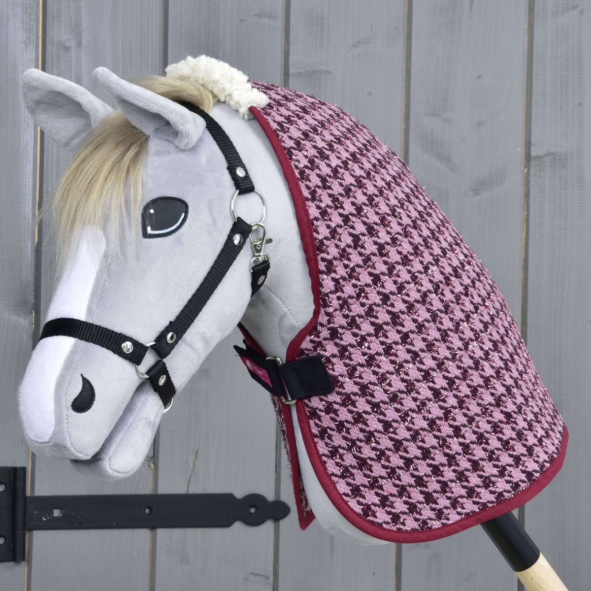 Light grey Hobby Horse in a black halter wearing the Stable Blanket Winter Magic in pink and burgundy houndstooth