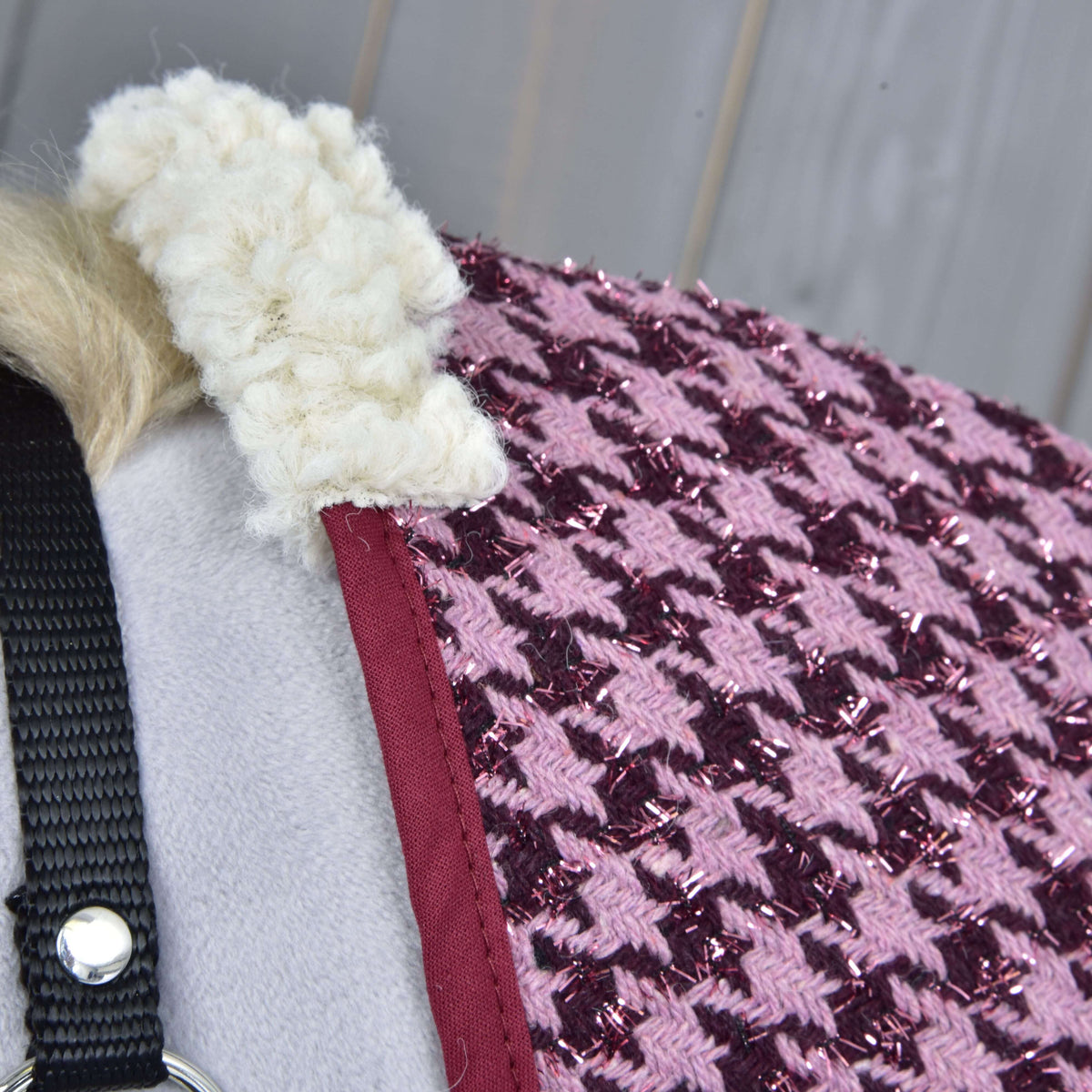Close-up of the cream fleece at the withers, the burgundy binding and the glittery pink houndstooth weave