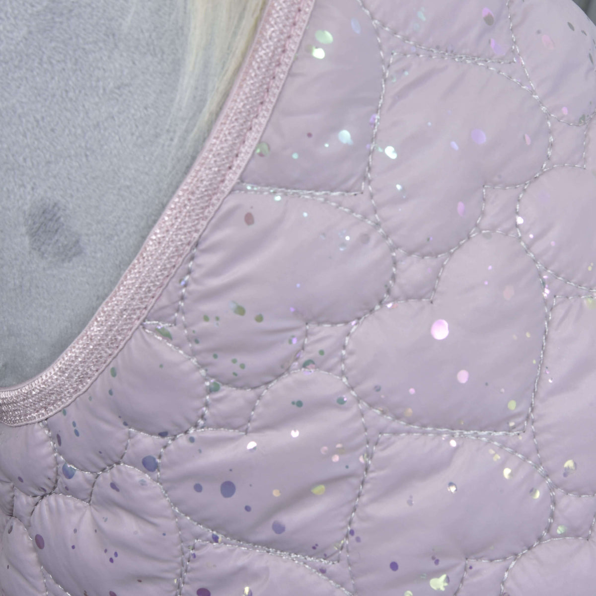 Detail of the lilac blanket fabric with heart-shaped quilting, iridescent glitter dots and a sparkly trim