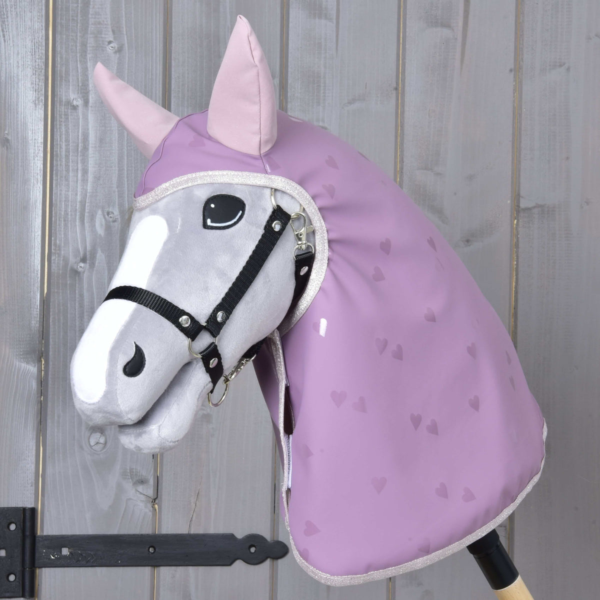 Grey Hobby Horse in a black halter wearing the Raincoat Sweetheart, lilac with tone-on-tone hearts and pale pink ears