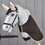 Grey Hobby Horse in a black halter wearing Set Thermo Sweety, the quilted brown blanket and ear bonnet with pink ears