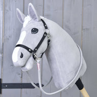 Light grey Hobby Horse in a black halter wearing the grey Reins Tizian with pink wraps clipped under its chin