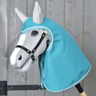 Grey Hobby Horse in a black halter wearing the Raincoat Turquoise with hood and light grey ears, covering head and neck