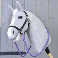 Light grey Hobby Horse in a black halter wearing the purple Reins Viola clipped to both sides of the halter