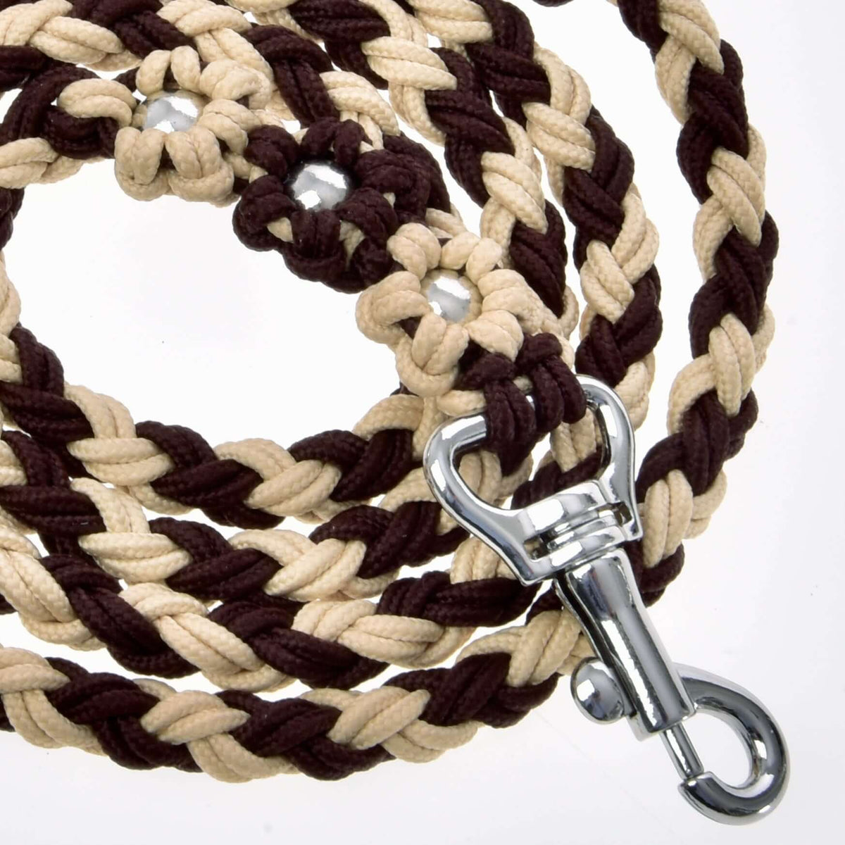 Coiled brown and beige braided lead rope with its bead flowers and silver snap hook seen up close