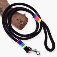 LarDen Hobby Horse Lead Rope Rainbow, black rope lead with neon rainbow wraps and silver snap hook coiled on a branch