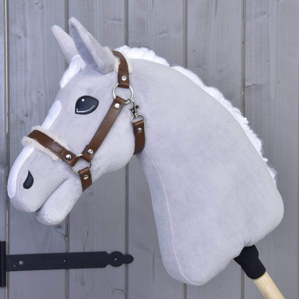 Light grey Hobby Horse with white mane wearing the brown leatherette halter with cream fur on noseband and crownpiece