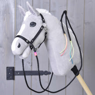 Grey Hobby Horse in a black halter wearing the black western reins, with neon cord tassels hanging on its neck