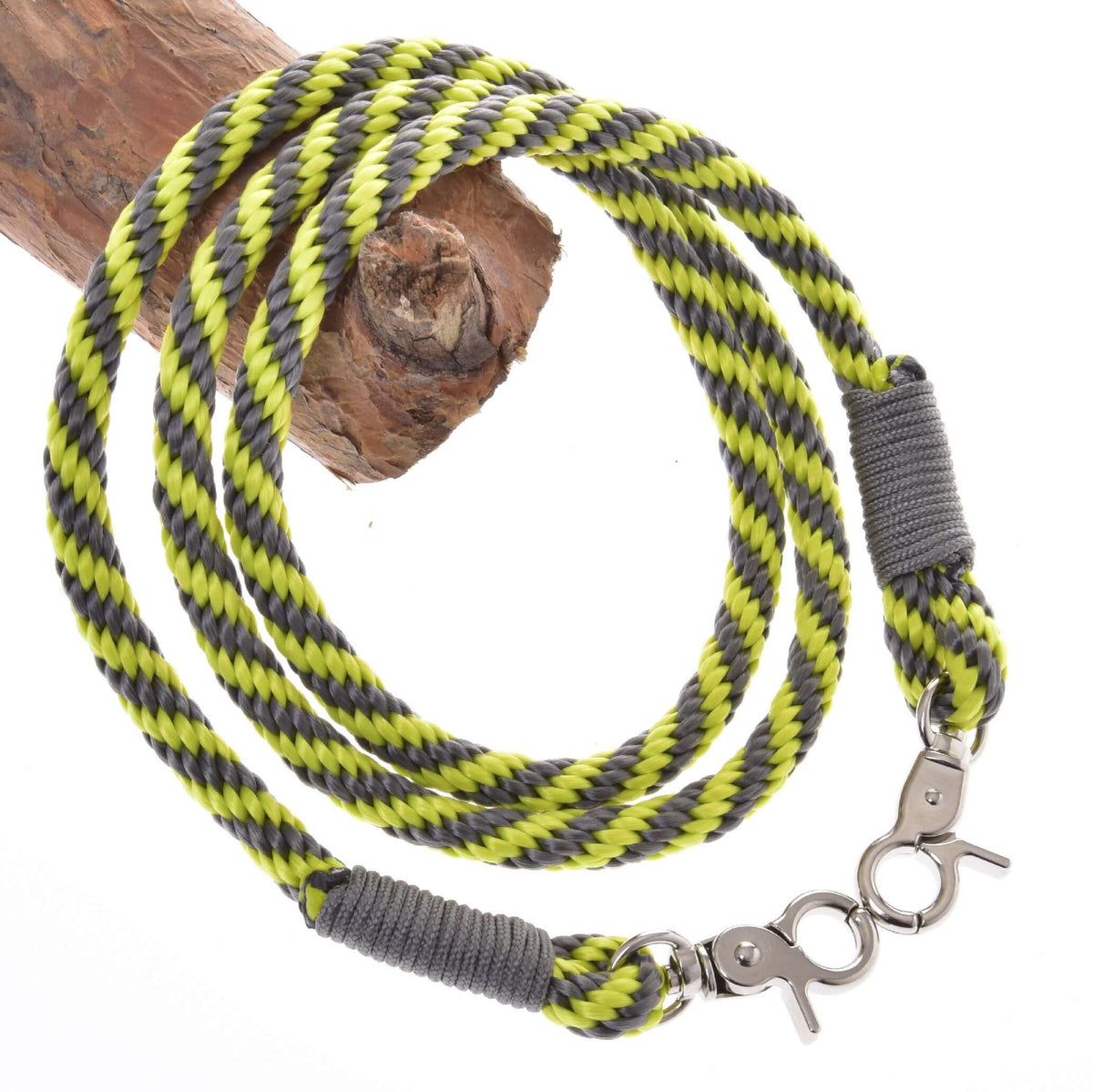 Hobby Horse reins in lime and grey striped rope with grey wraps and two silver snap hooks over a branch