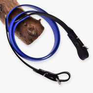 LarDen Hobby Horse Rubberized reins blue with a grippy honeycomb texture and black buckled ends, over a branch